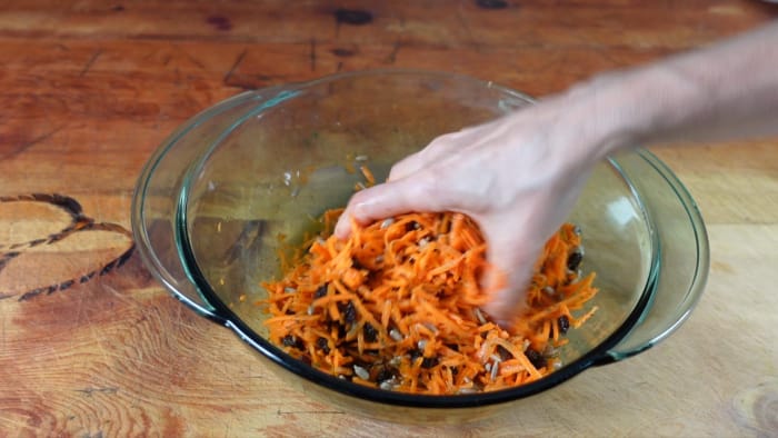 mixing the carrot salad