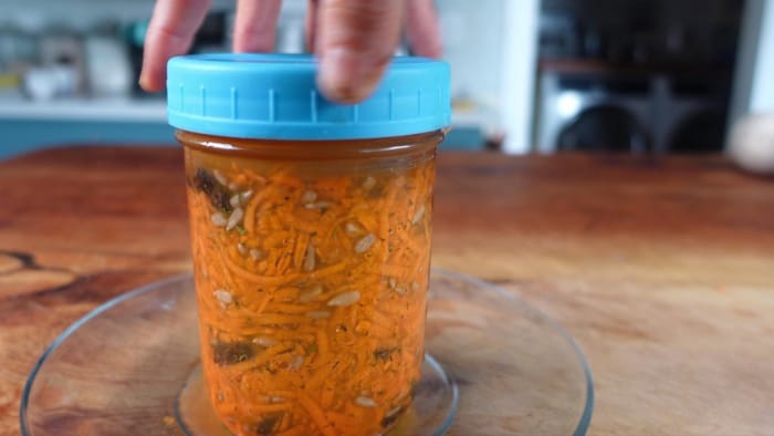 placing the lid on the jar